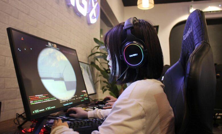a person wearing headphones sitting in front of a computer